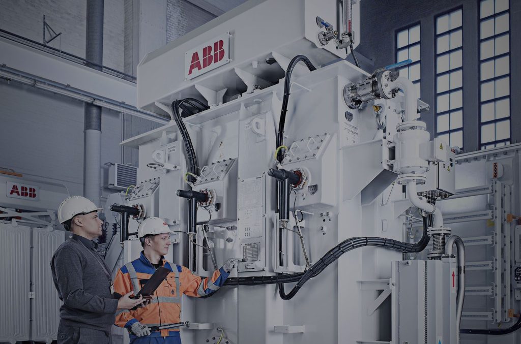 Picture of a large production machine in front of which a man stands. Automated material flow ensures productivity for his company