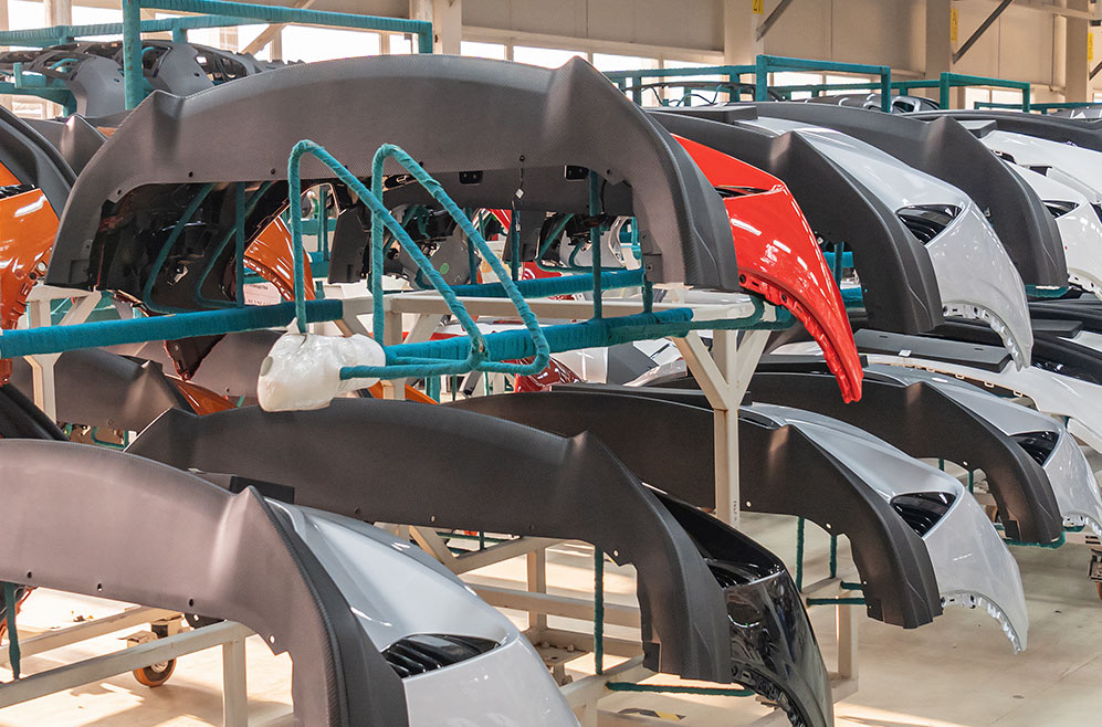 Auto bumpers parts are installed on the racks after painting in the car factory. RFID tracks each bumper