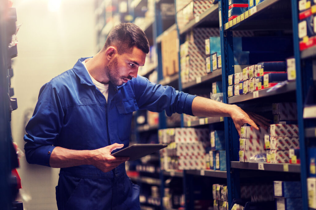 Person in work overalls picking parts or tools for their work - showcasing Unmanned RFID Stores