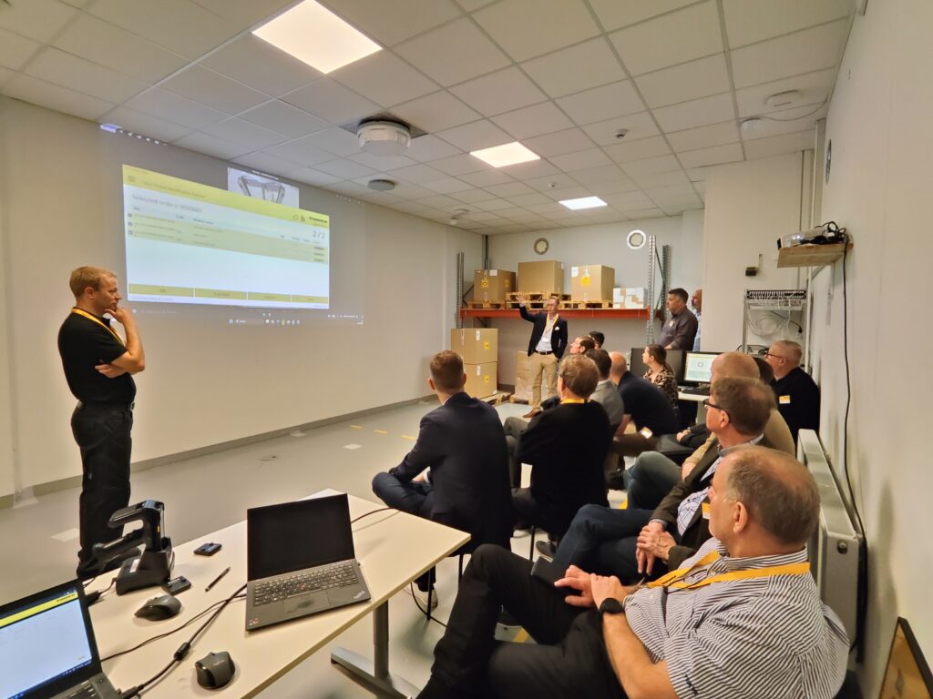 People together in the Showroom event, they are all watching a presentation on how RFID works