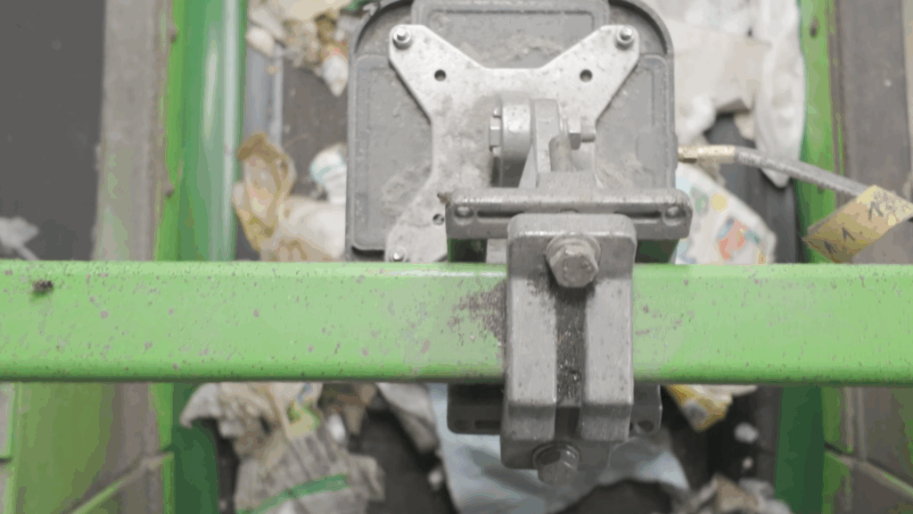 A close-up to an RFID antenna that is set above a waste stream in a waste sorting facility