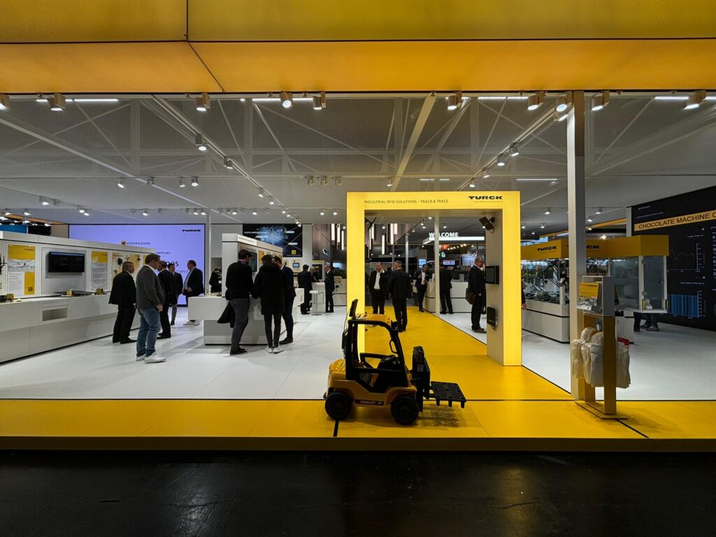 SPS exhibition, showing RFID gate and people talking in the stand