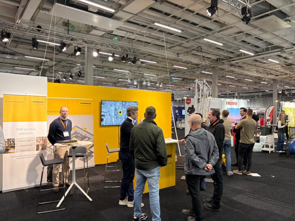 Picture of a busy exhibition booth with people busstling