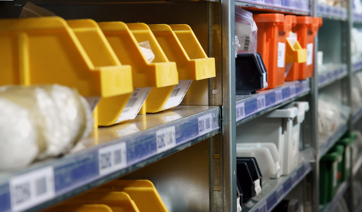 A picture of plastic bins on shelves to indicate how rfid-based kanban works