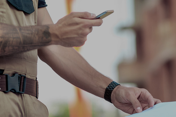 closeup to a person reading something with their phone from a paper