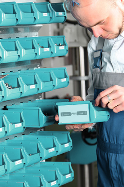 A person looks for materials in an RFID-tagged box