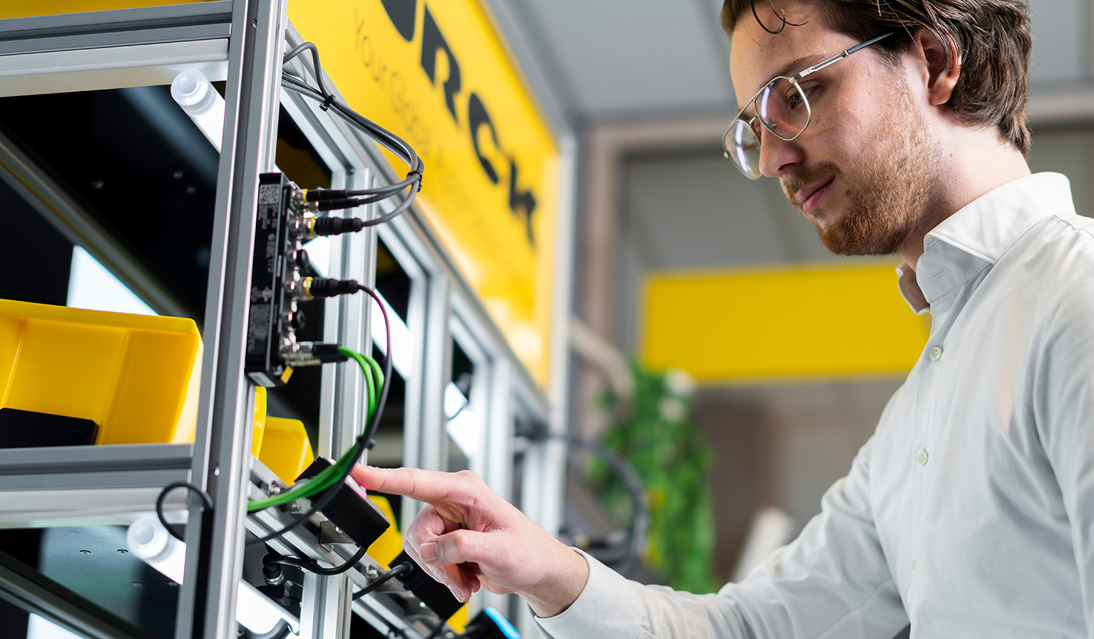 A person from below picking something from a shelf for pick to light