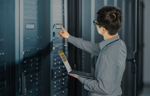 ServerRoom RFID Tracking – Turck Vilant Systems A person entering a server room holding a laptop